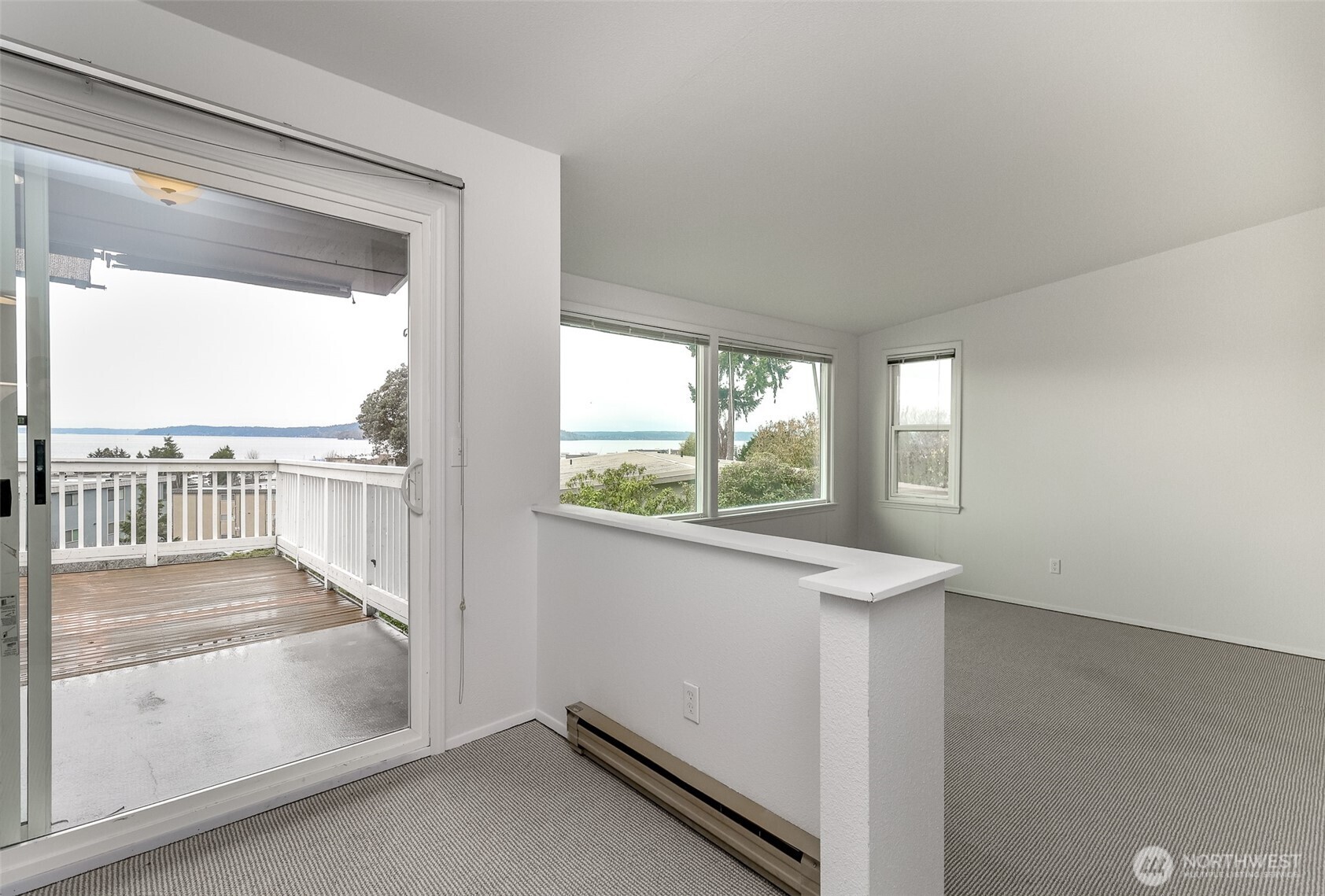 842 South 227th Place, Unit A Des Moines, WA 98198 - Photo 20 of 39 an empty room with wooden floor and windows
