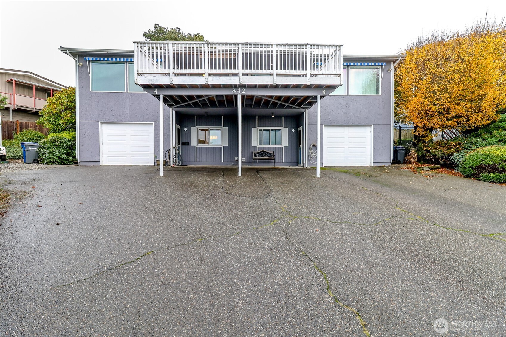 842 South 227th Place, Unit A Des Moines, WA 98198 - Photo 2 of 39 a front view of a house with a garden and garage