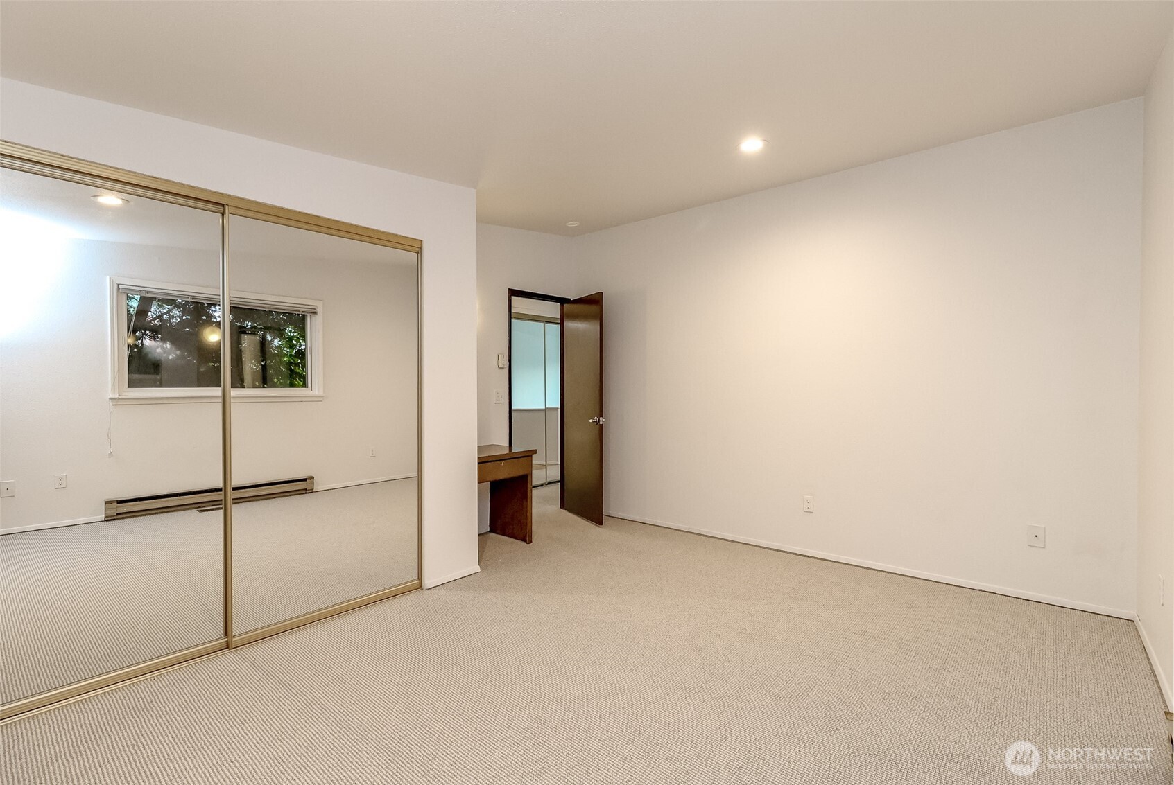 842 South 227th Place, Unit A Des Moines, WA 98198 - Photo 22 of 39 an empty room with a refrigerator and mirror