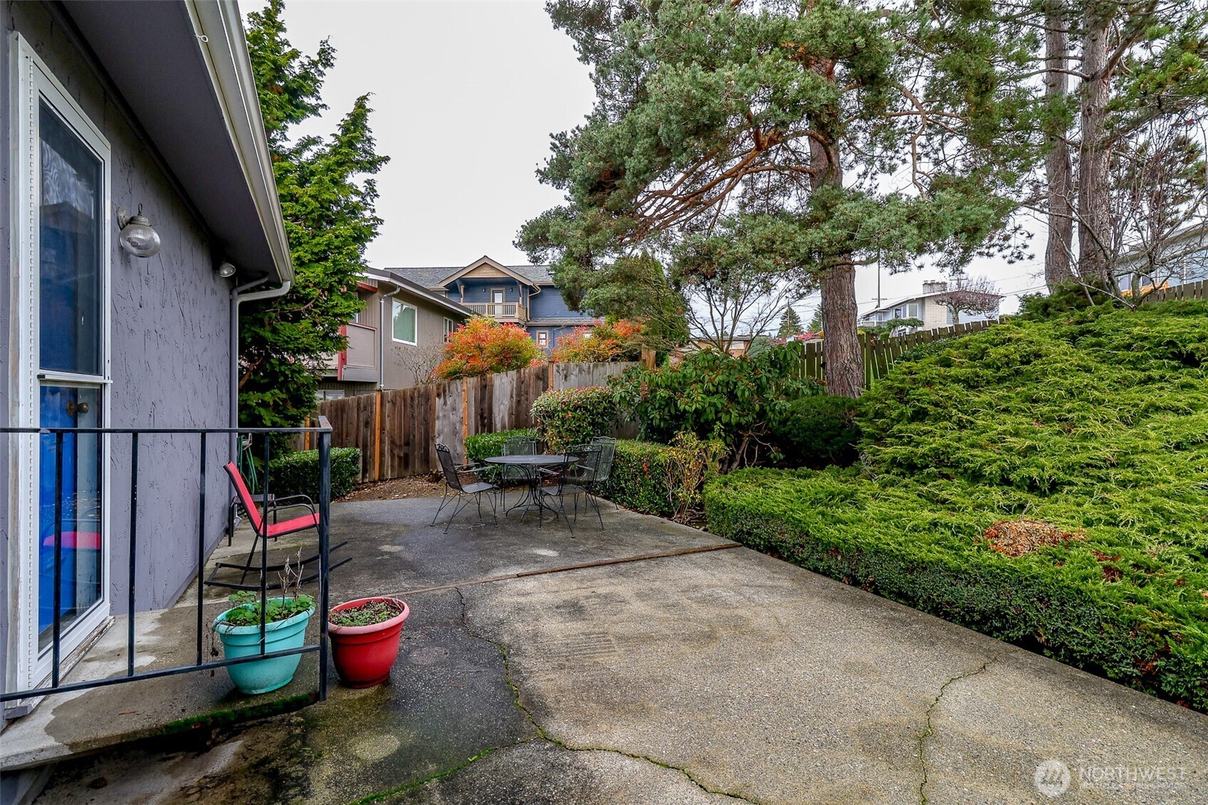842 South 227th Place, Unit A Des Moines, WA 98198 - Photo 27 of 39 a view of a chair and table in backyard of the house