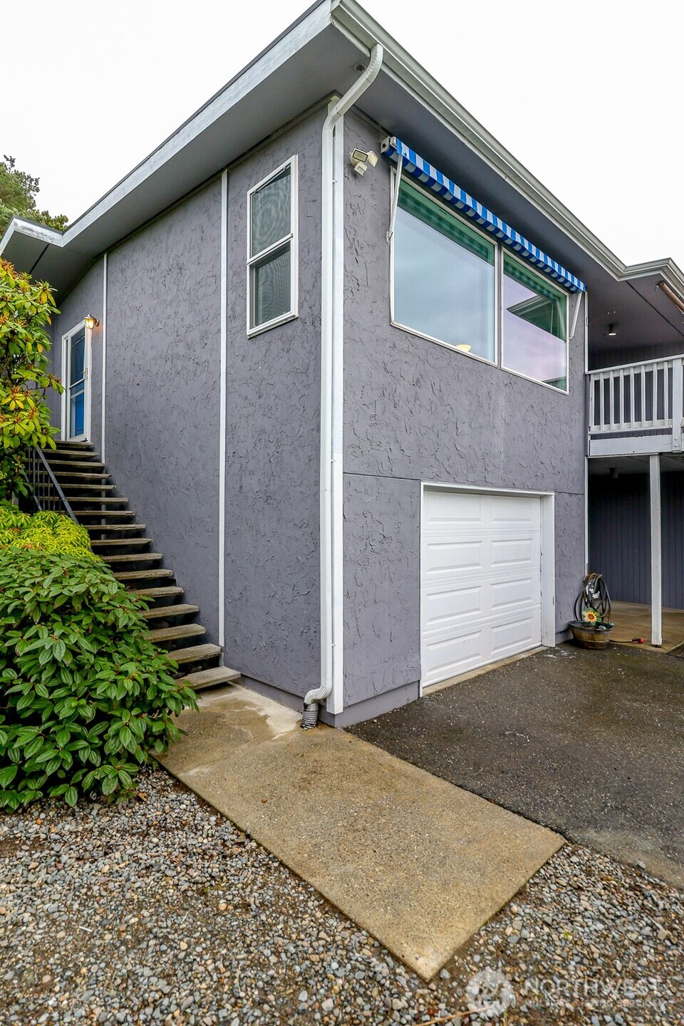 842 South 227th Place, Unit A Des Moines, WA 98198 - Photo 32 of 39 a view of a house with a yard and garage