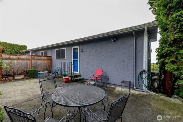 a backyard of a house with outdoor seating
