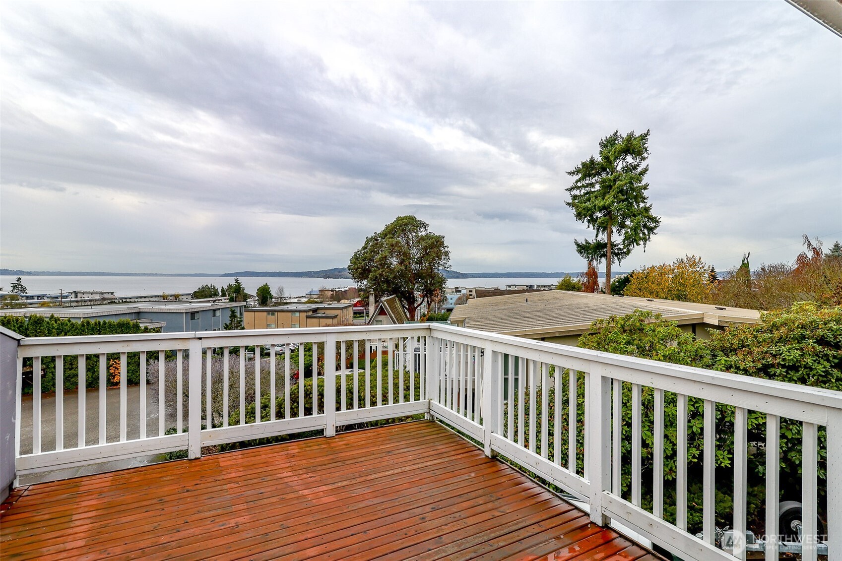 842 South 227th Place, Unit A Des Moines, WA 98198 - Photo 5 of 39 a view of a balcony with wooden floor