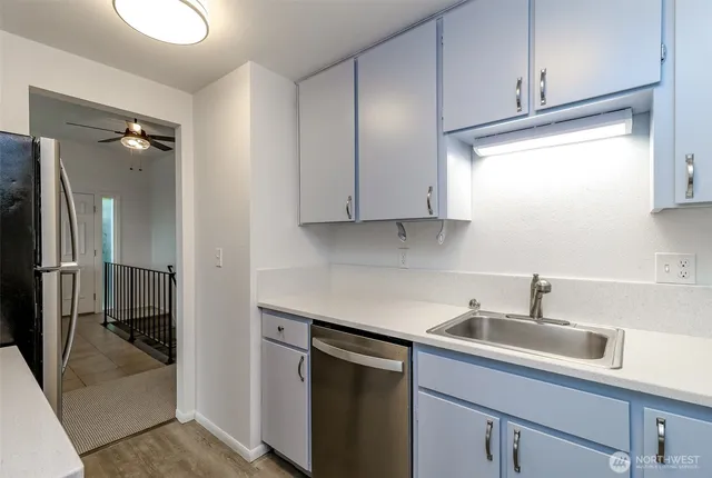 a kitchen with a sink and cabinets