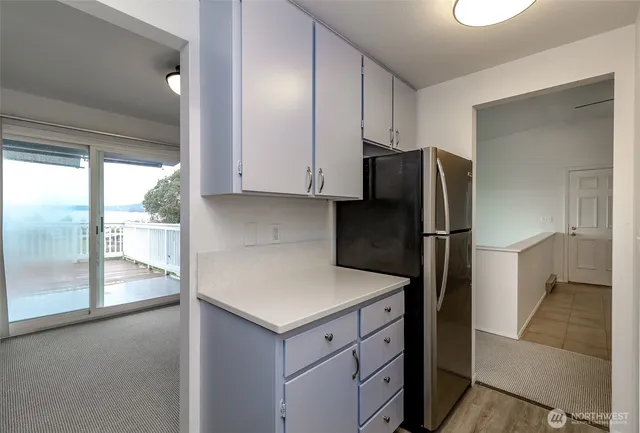 a kitchen with a refrigerator and a sink