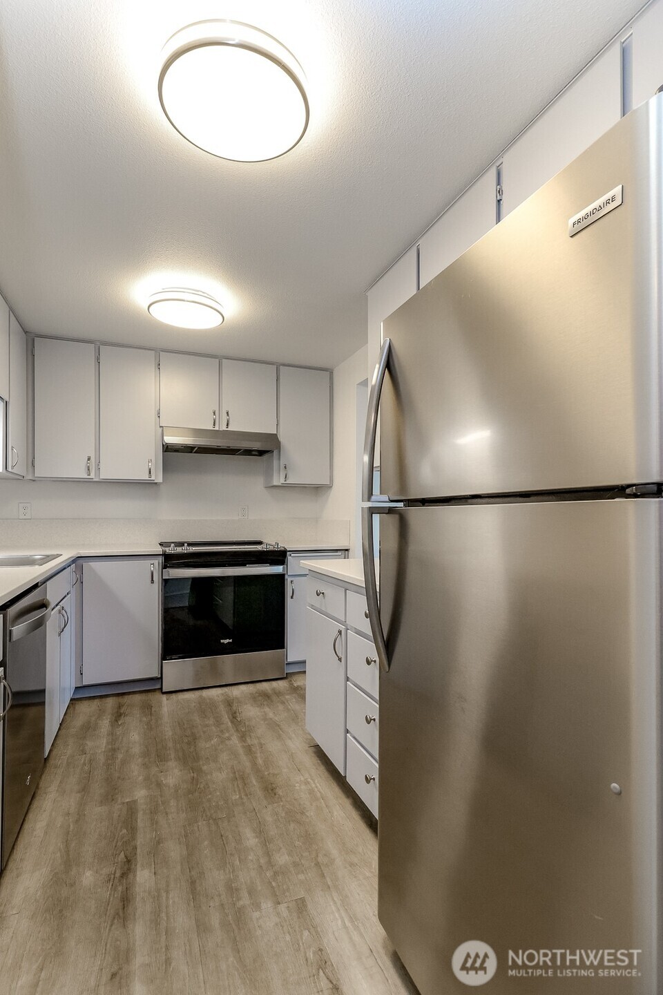 842 South 227th Place, Unit A Des Moines, WA 98198 - Photo 9 of 39 a kitchen with stainless steel appliances granite countertop a refrigerator a sink and a stove