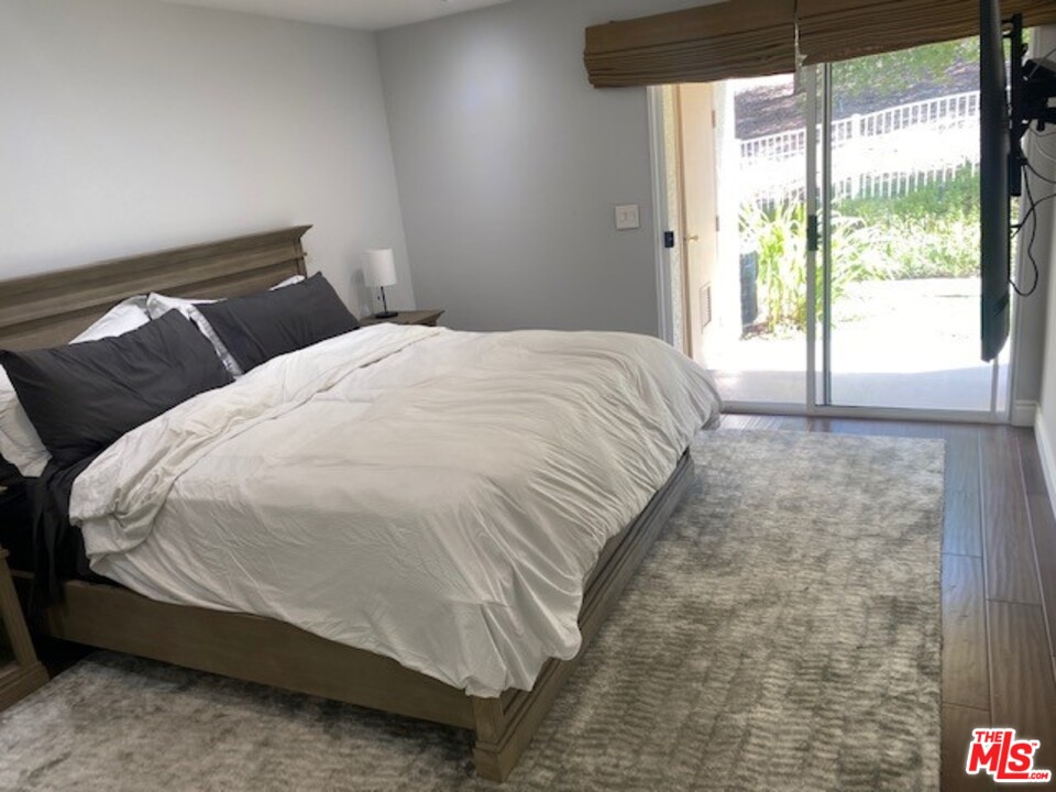 5805 Oak Bend Lane, Unit 210 Oak Park, CA 91377 - Photo 13 of 20 a bedroom with a bed and a window