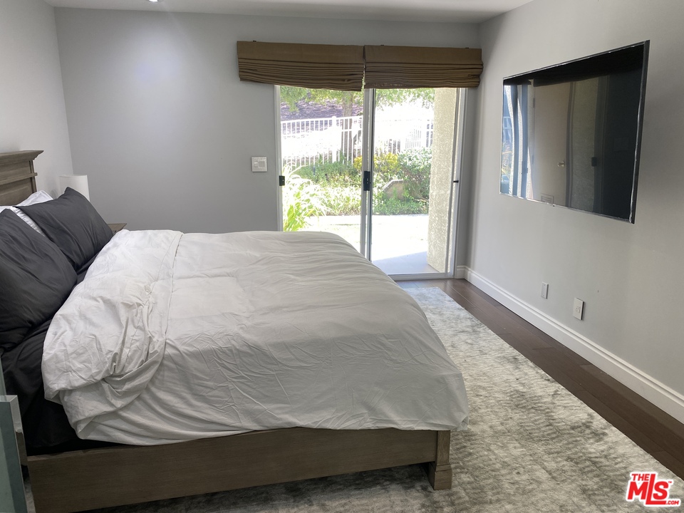 5805 Oak Bend Lane, Unit 210 Oak Park, CA 91377 - Photo 14 of 20 a bedroom with a bed and window