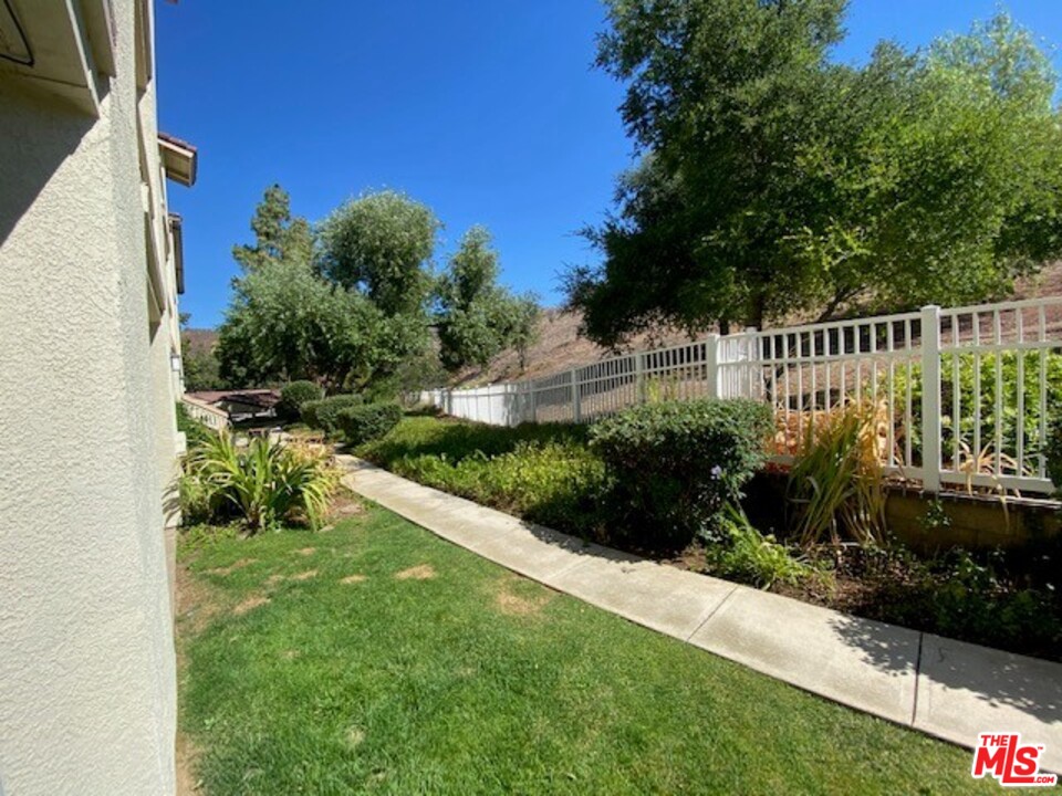 5805 Oak Bend Lane, Unit 210 Oak Park, CA 91377 - Photo 20 of 20 a view of a chair and table in the garden