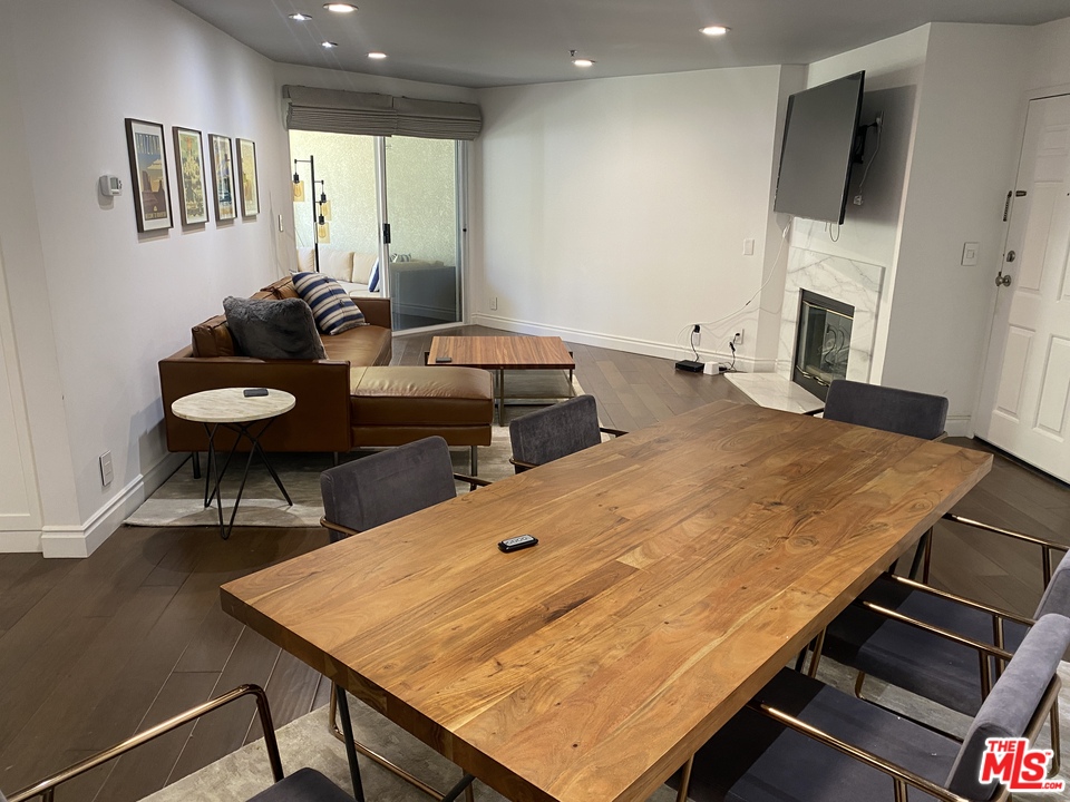 5805 Oak Bend Lane, Unit 210 Oak Park, CA 91377 - Photo 5 of 20 a room with a table chairs and a kitchen view