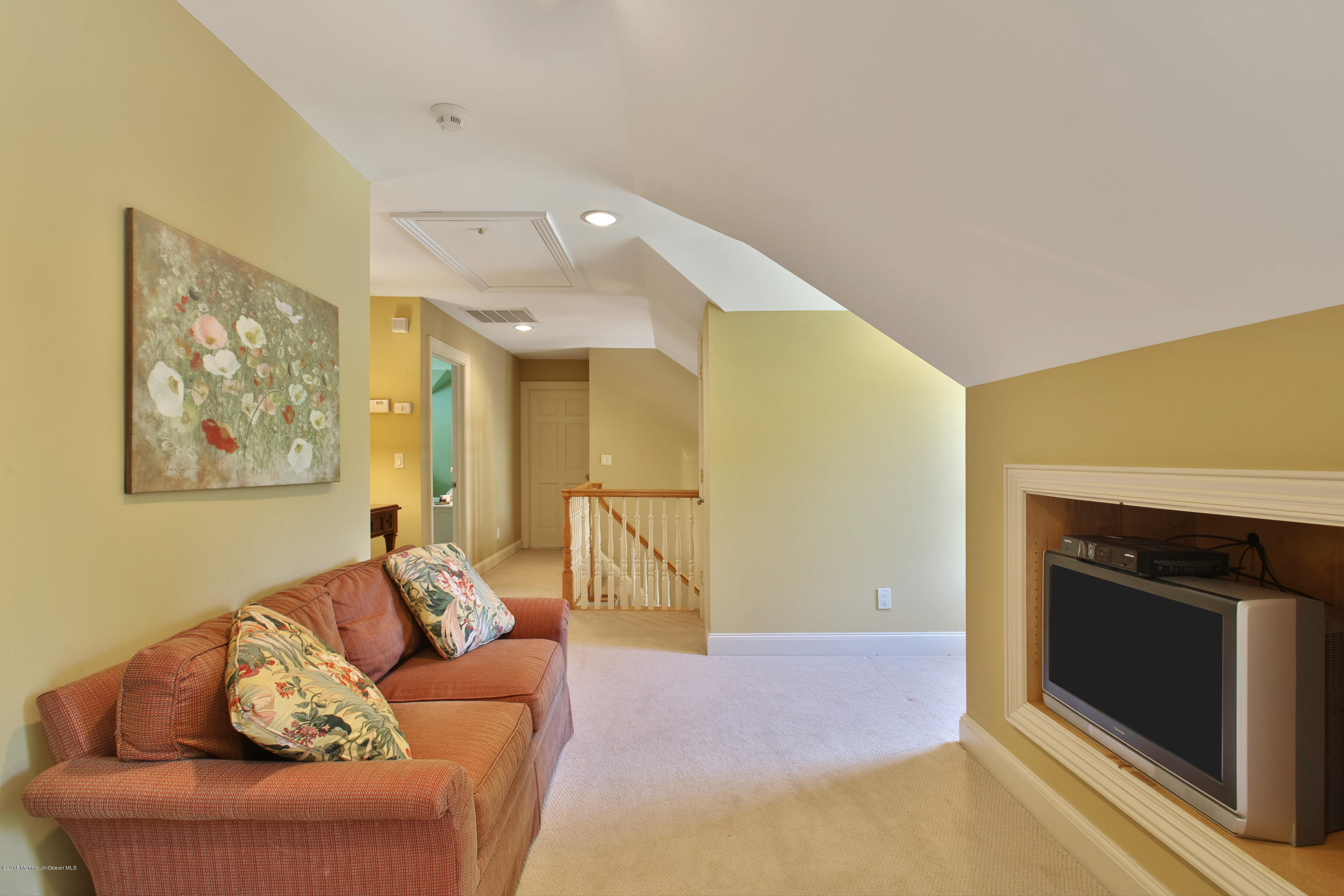7 Partridge Way Colts Neck, NJ 07722 - Photo 37 of 50 a living room with furniture a flat screen tv and a fireplace