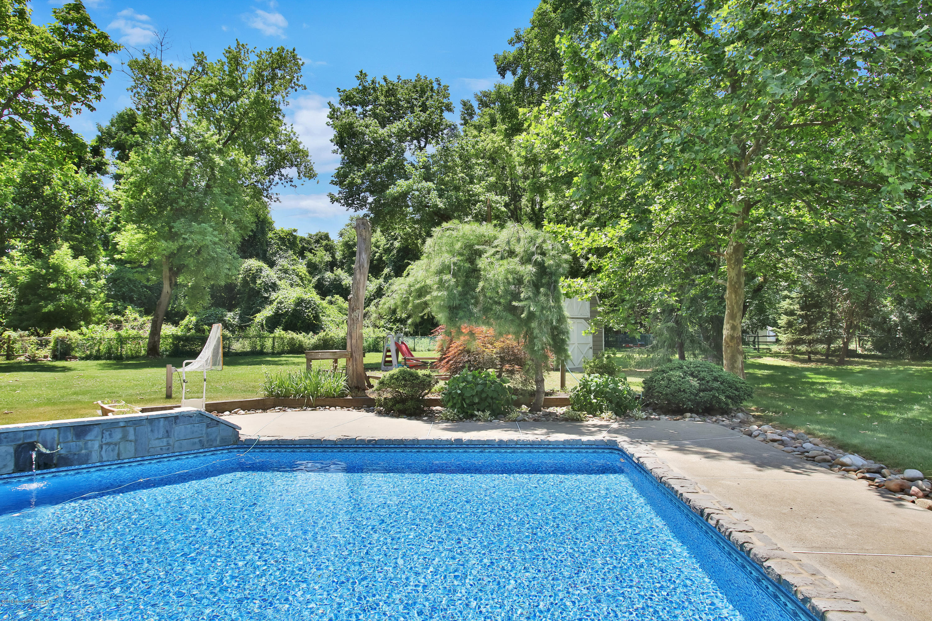 7 Partridge Way Colts Neck, NJ 07722 - Photo 42 of 50 a view of a yard with plants and large trees