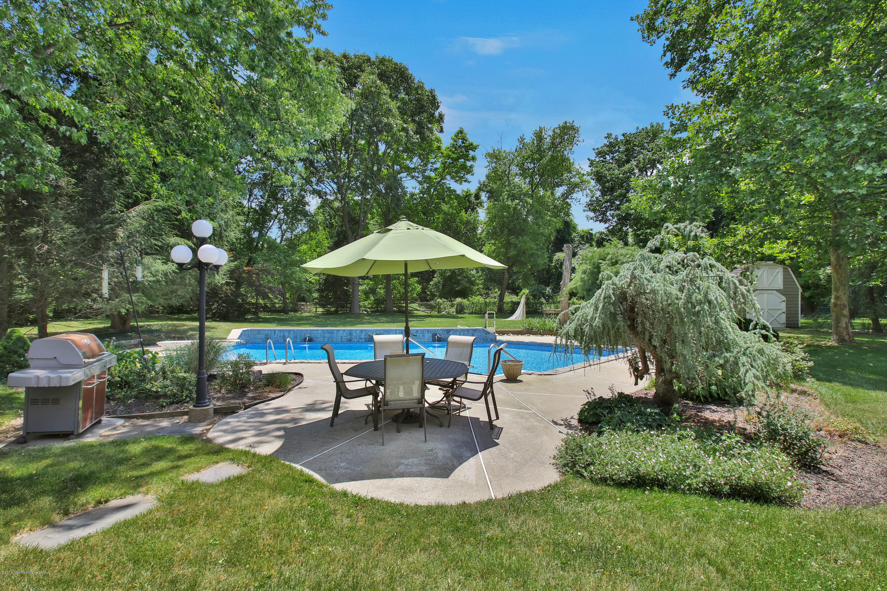 7 Partridge Way Colts Neck, NJ 07722 - Photo 44 of 50 a view of a patio with table and chairs under an umbrella