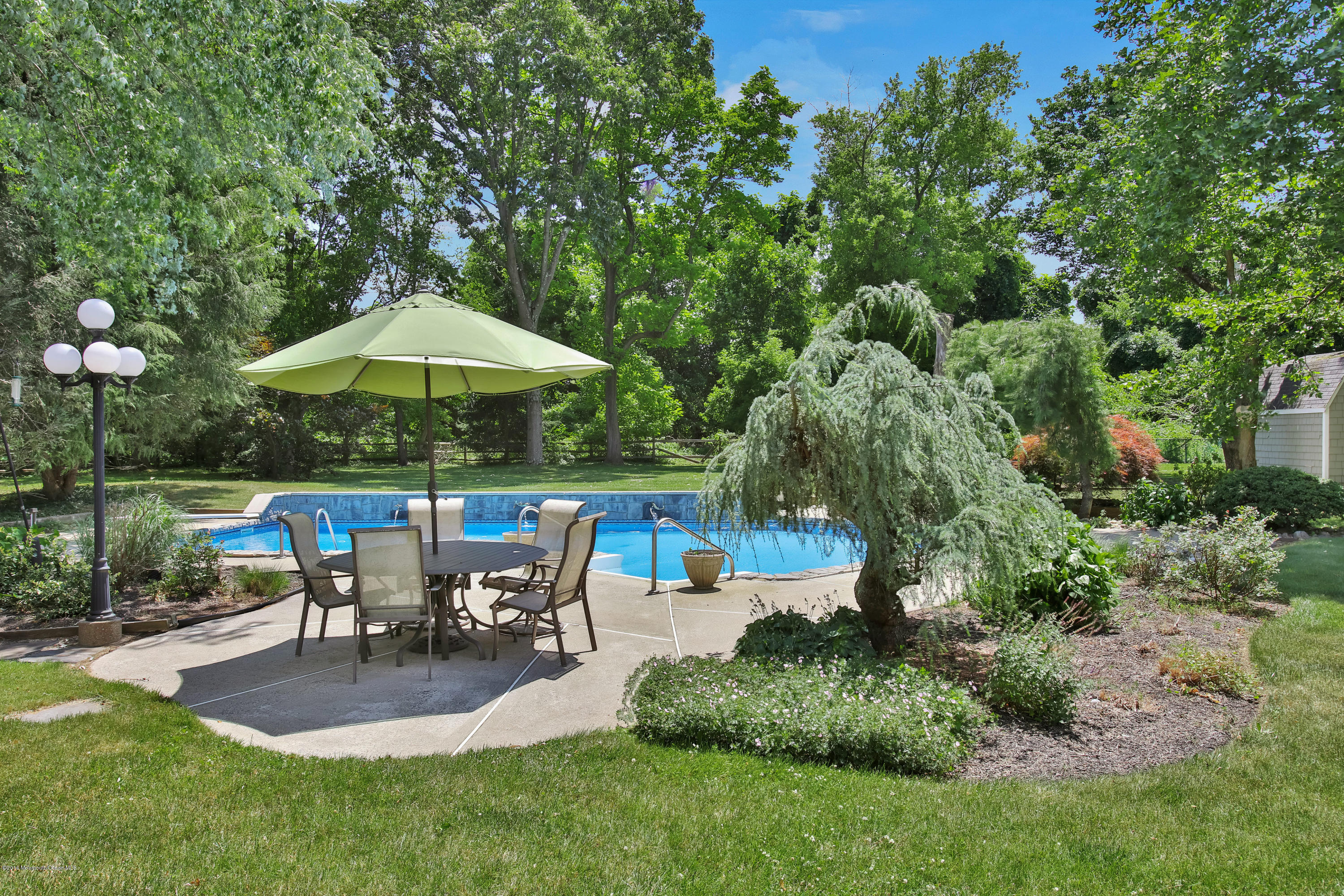7 Partridge Way Colts Neck, NJ 07722 - Photo 50 of 50 a view of a table and chairs under an umbrella