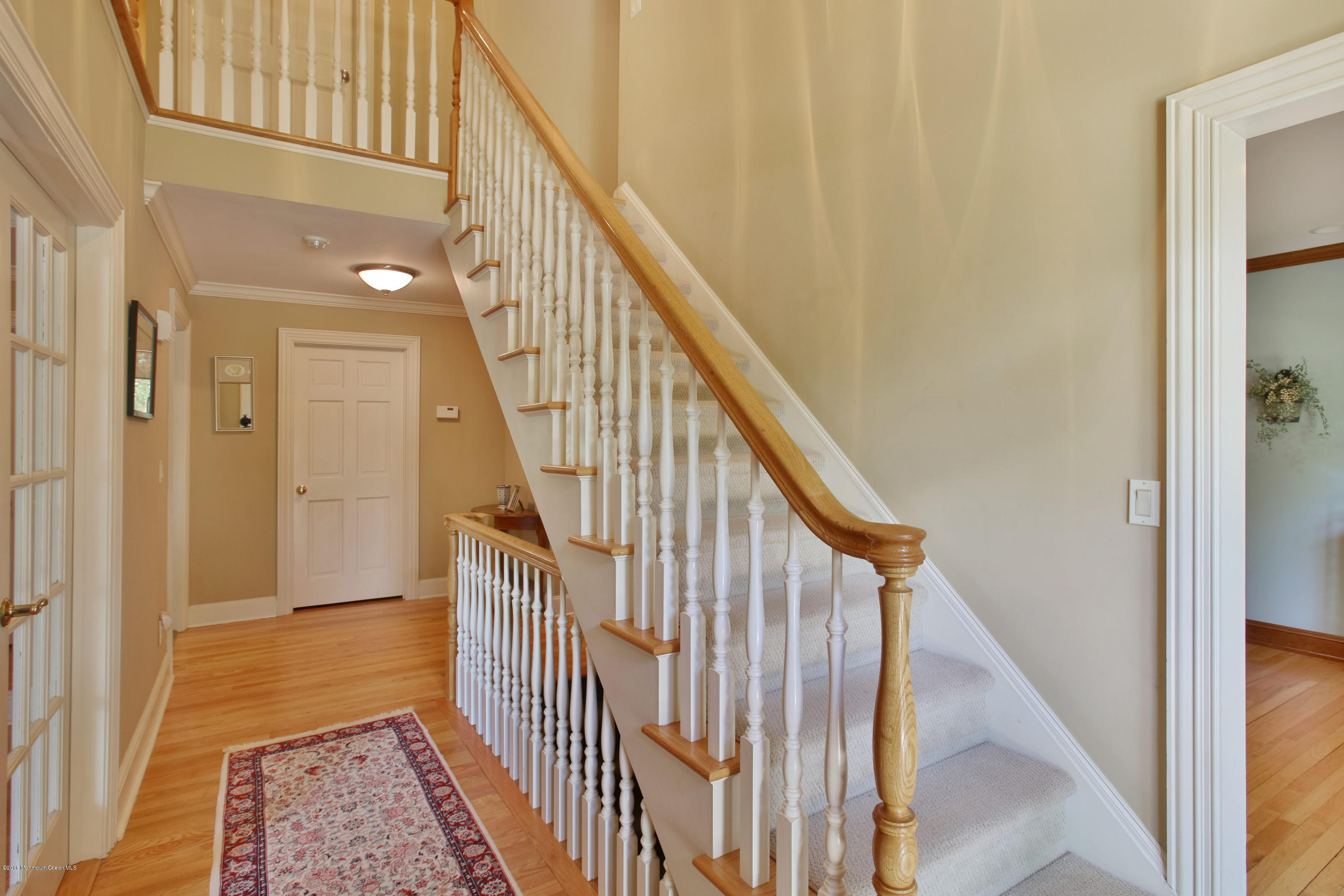 7 Partridge Way Colts Neck, NJ 07722 - Photo 7 of 50 a view of staircase with wooden floor and a rug
