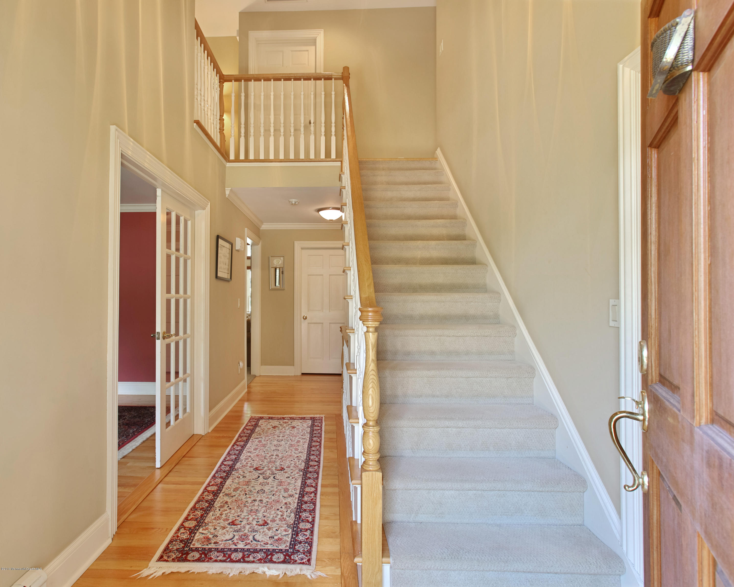 7 Partridge Way Colts Neck, NJ 07722 - Photo 8 of 50 a view of a hallway with wooden floor and staircase