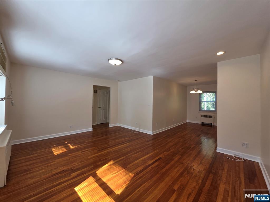 245 Johnson Avenue, Unit K1 Hackensack, NJ 07601 - Photo 2 of 15 wooden floor in an empty room with a window