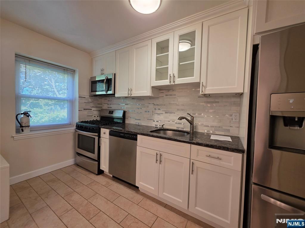 245 Johnson Avenue, Unit K1 Hackensack, NJ 07601 - Photo 8 of 15 a kitchen with granite countertop a refrigerator stove and sink
