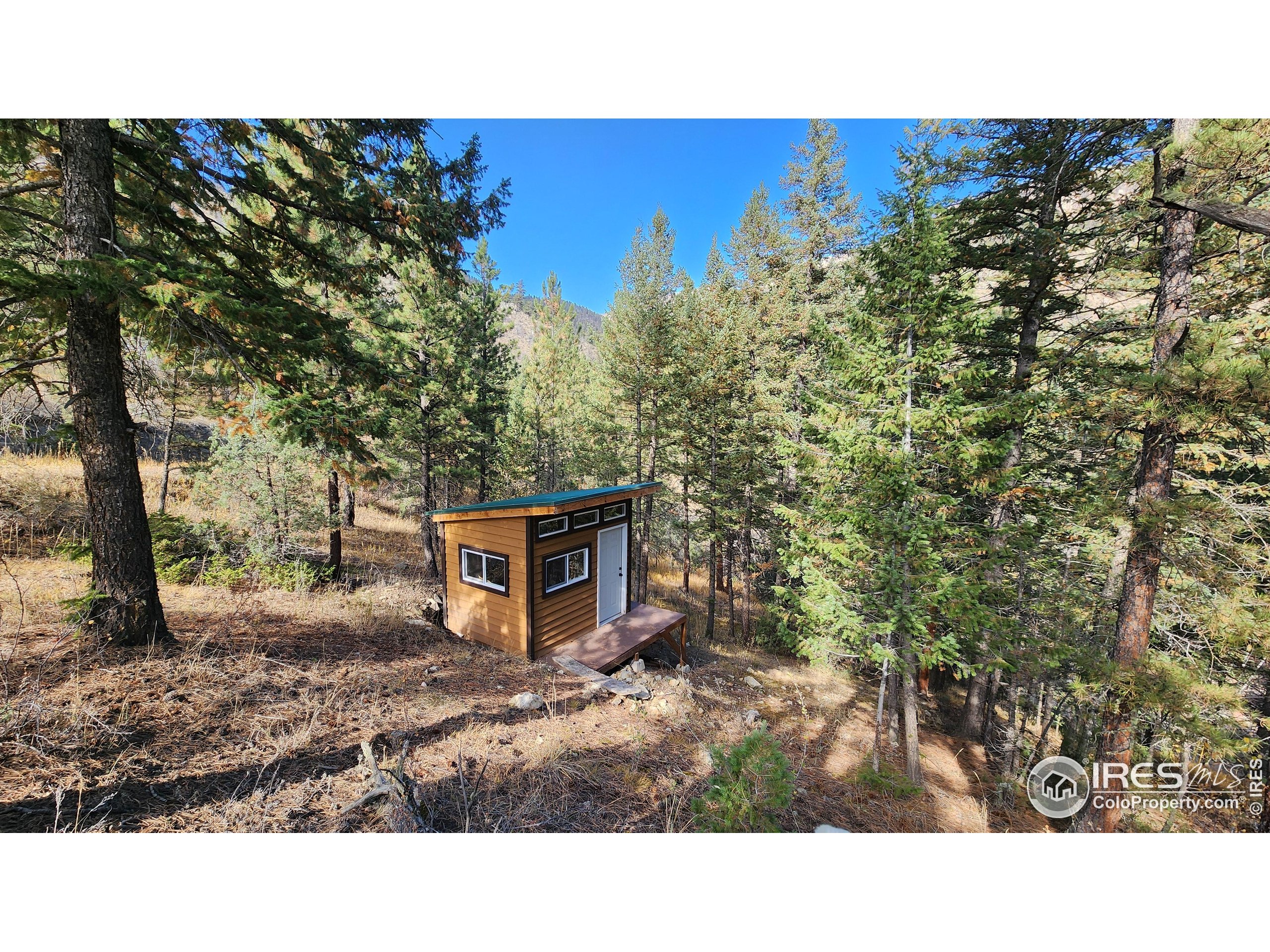 84 Copper Hill Road Drake, CO 80515 - Photo 13 of 28 a balcony with a bench and trees
