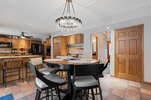 a view of a dining room with furniture a chandelier and wooden floor