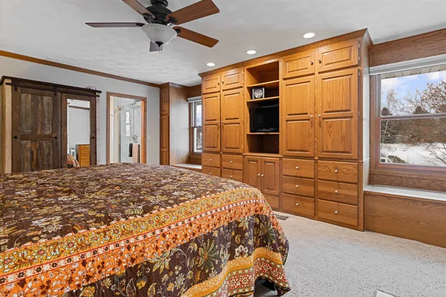 a bedroom with a large bed and flat tv