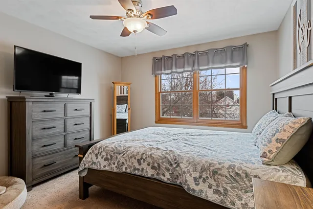 a living room with furniture kitchen view and a flat screen tv