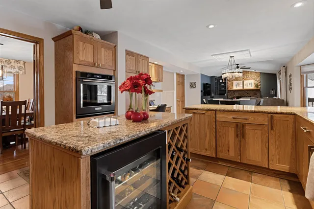 a kitchen with granite countertop a sink cabinets and appliances
