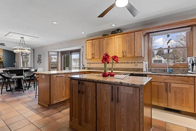 a kitchen with stainless steel appliances granite countertop a refrigerator and cabinets