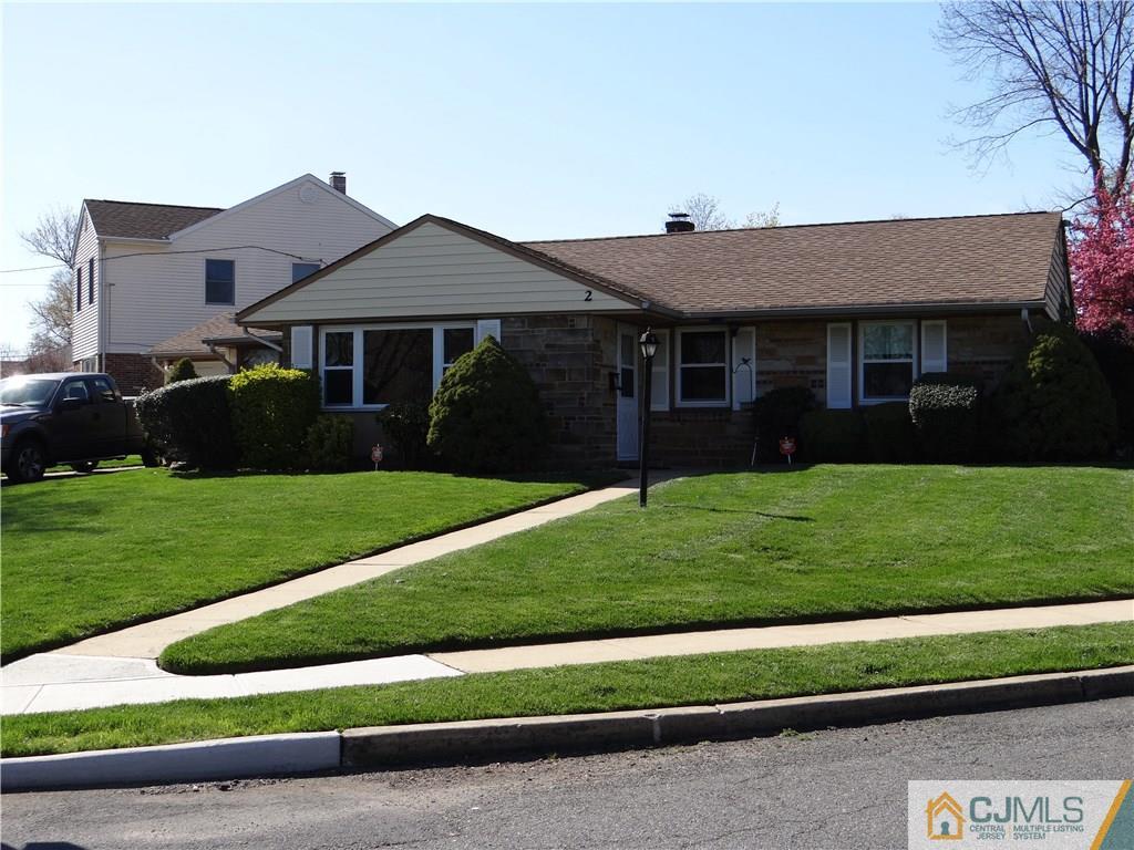 2 Roger Road Edison, NJ 08817 - Photo 2 of 16 a front view of a house with a yard and garage