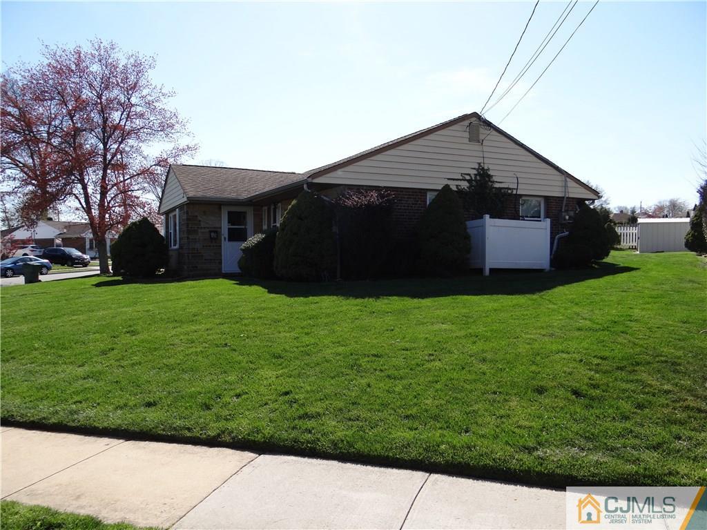 2 Roger Road Edison, NJ 08817 - Photo 3 of 16 a view of a house with a small yard and a large tree