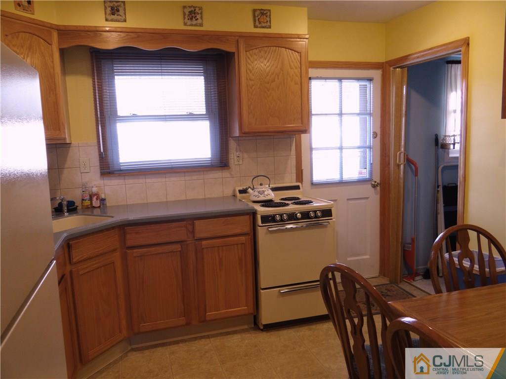 2 Roger Road Edison, NJ 08817 - Photo 7 of 16 a kitchen with stainless steel appliances granite countertop a sink a stove cabinets and a window