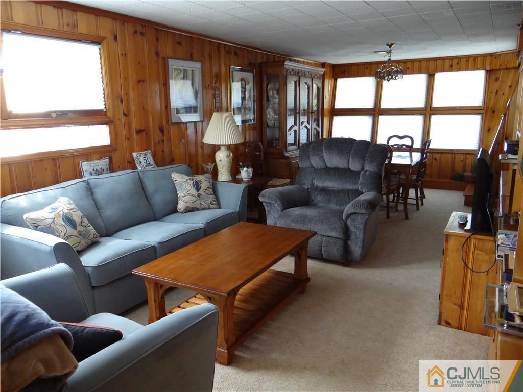 2 Roger Road Edison, NJ 08817 - Photo 10 of 16 a living room with furniture and a floor to ceiling window