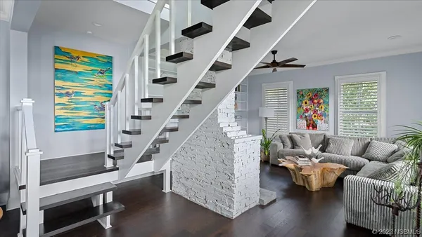 a kitchen with stainless steel appliances granite countertop a stove top oven a sink a stove and a wooden floors