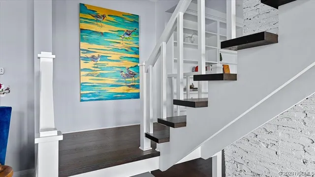 a view of a chair and tables in the balcony