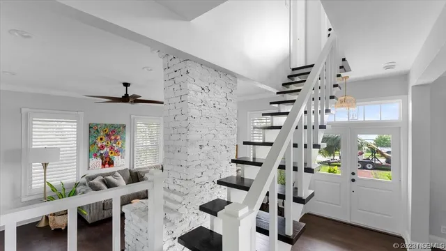 a view of a backyard with table and chairs and potted plants and large trees
