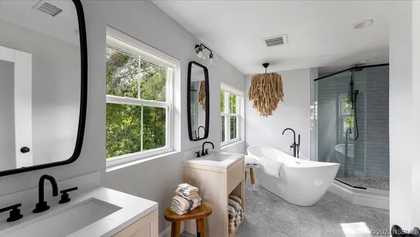 a front view of a house with a yard and green space