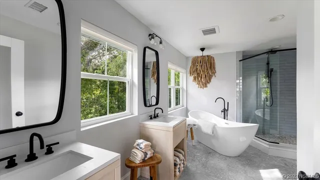 a front view of a house with a yard and green space