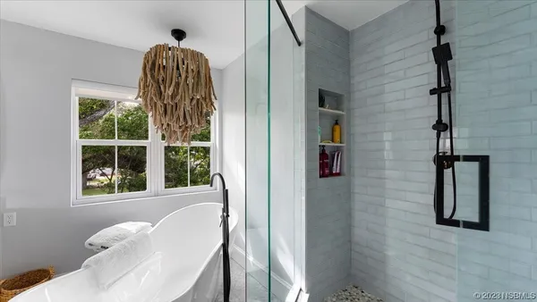 a view of a house with pool and sitting area