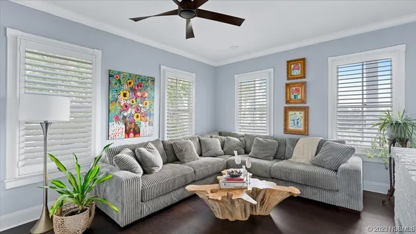 a view of a room with furniture and a window