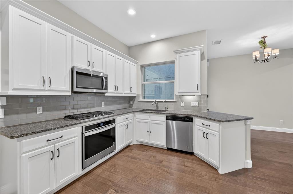 4224 Riverside Drive Flower Mound, TX 75028 - Photo 6 of 23 a kitchen with stainless steel appliances granite countertop white cabinets a sink and dishwasher