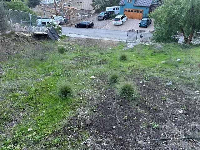 a view of a backyard with lawn chairs and a fire pit