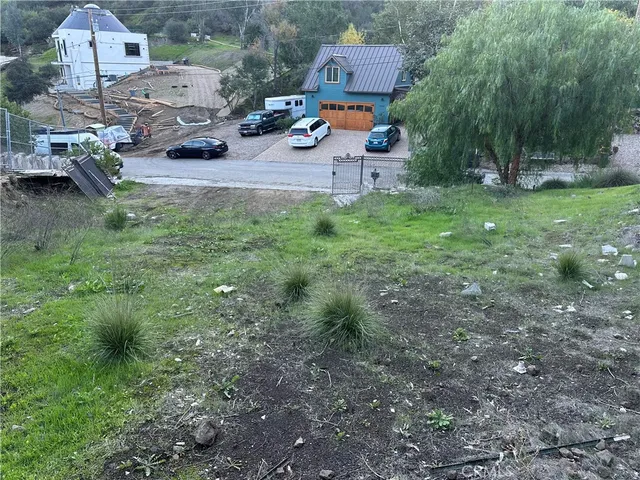 a backyard of a house with fire pit childrens swing and slide