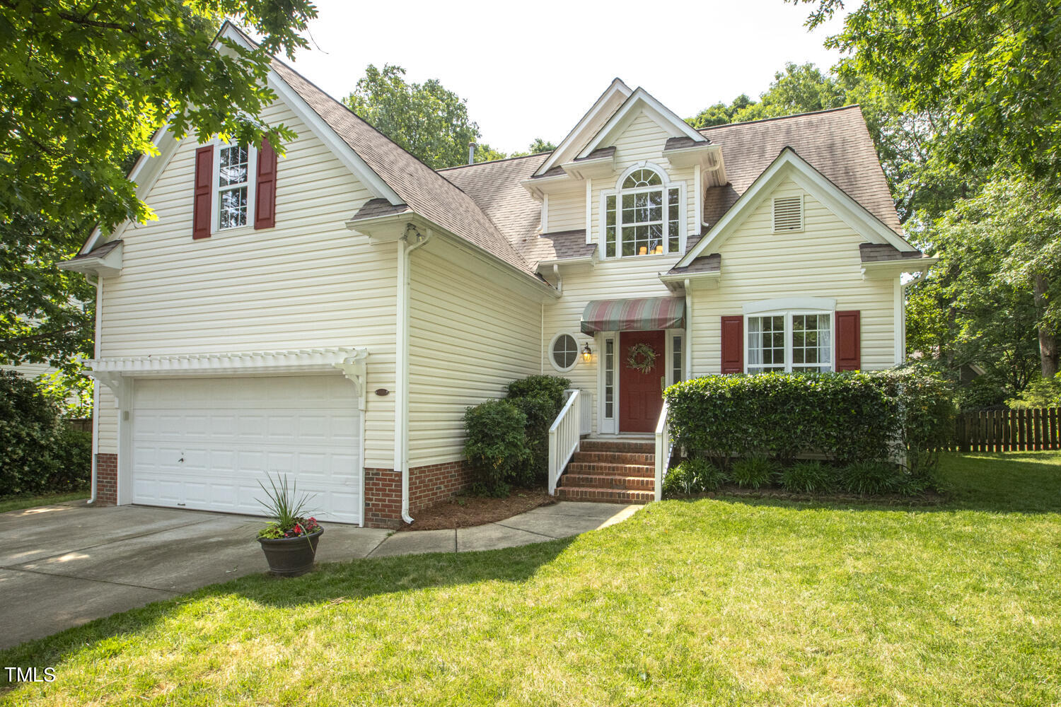 6409 Nowell Pointe Drive Raleigh, NC 27607 - Photo 1 of 29 a view of a yard in front of a house with plants and large tree