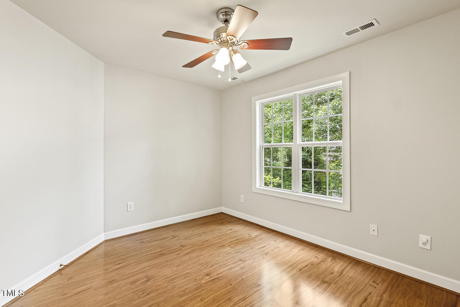 6409 Nowell Pointe Drive Raleigh, NC 27607 - Photo 23 of 29 an empty room with a window and a fan