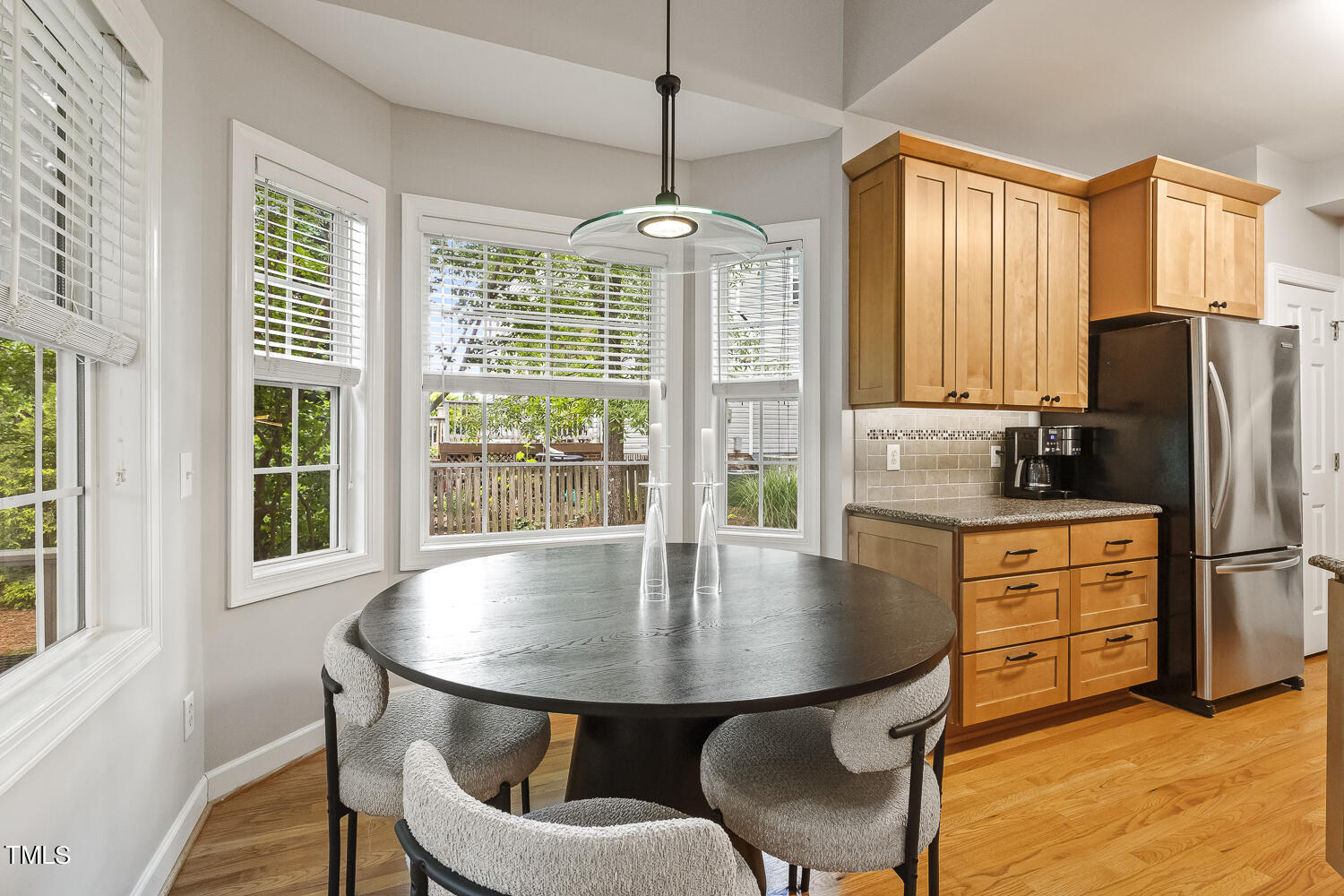 6409 Nowell Pointe Drive Raleigh, NC 27607 - Photo 9 of 29 a dining room with furniture a chandelier and window