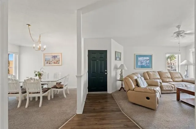 a living room with furniture and a dining table with rug