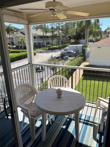 a view of a balcony with table and chairs