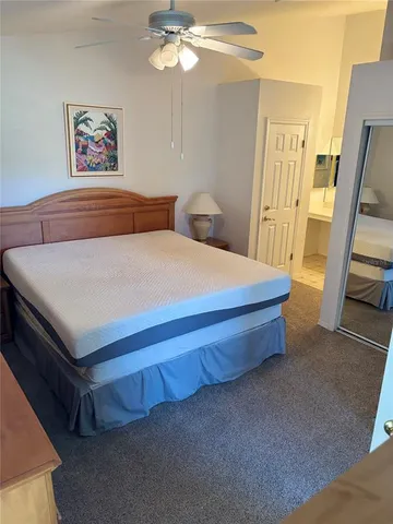 a spacious bedroom with a bed and a flat screen tv