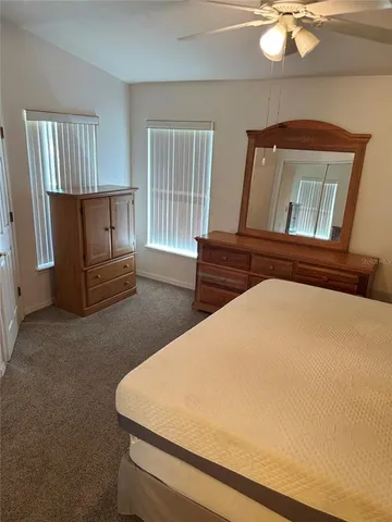 a bedroom with a bed and dresser