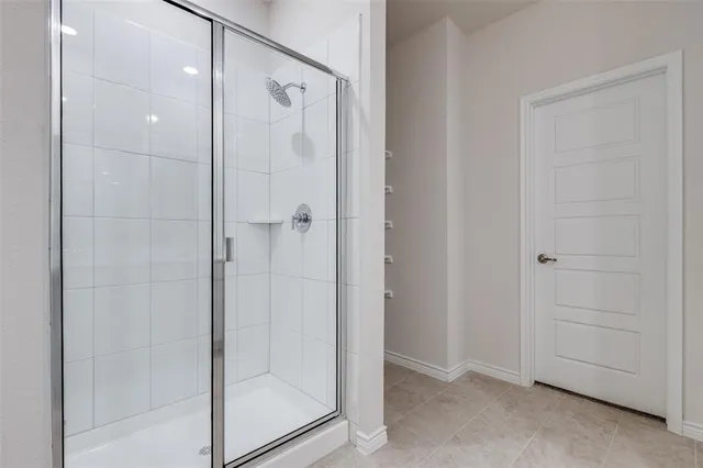 a bathroom with a glass shower door